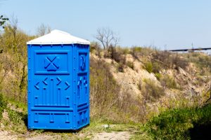 porta potty next to a road